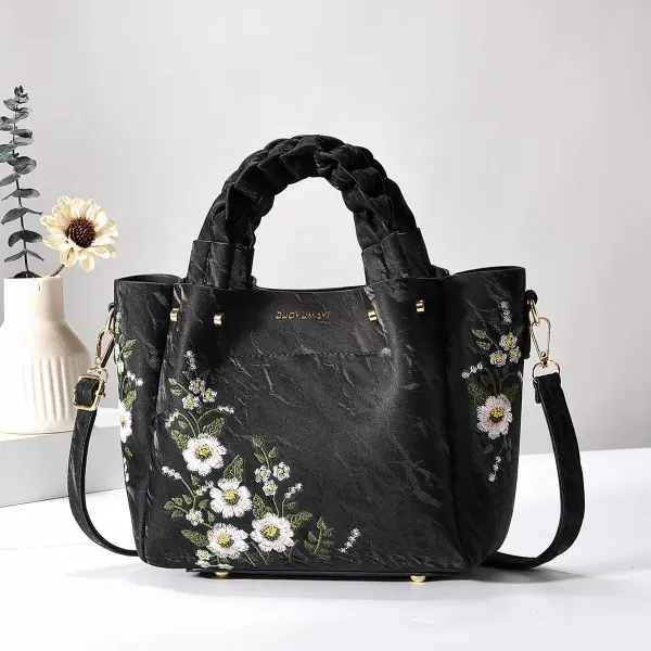 Jet Black Floral bag with braided handles, floral embroidery, and a long strap