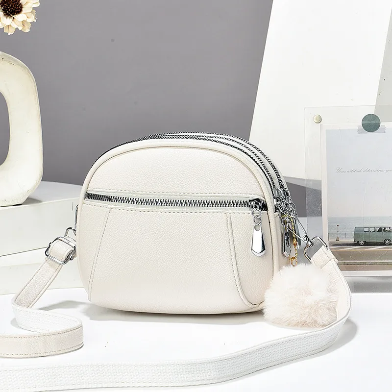 Women’s Solid Color Round Crossbody Bag In PU Leather With Fluff Ball And Single Shoulder Strap