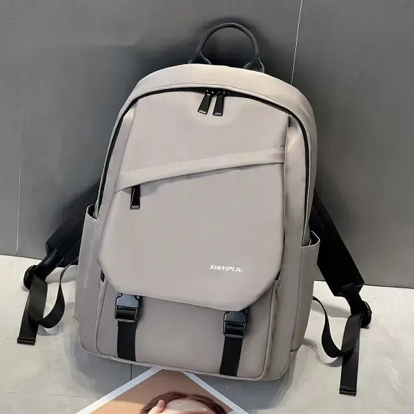 Khaki backpack, front view, showing the rounded top, front flap, buckle straps, and pockets