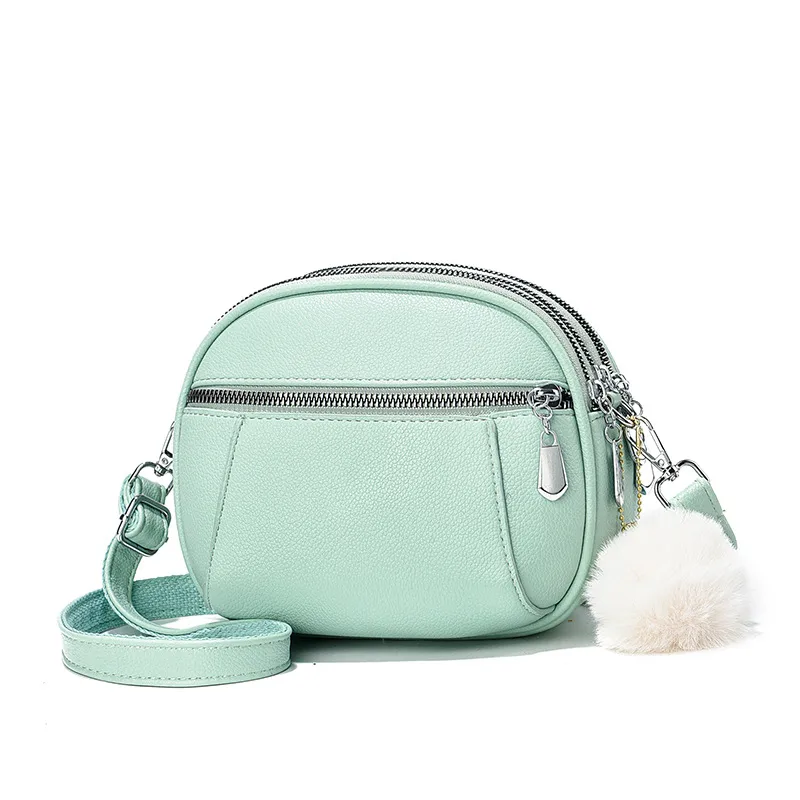 Women’s Solid Color Round Crossbody Bag In PU Leather With Fluff Ball And Single Shoulder Strap