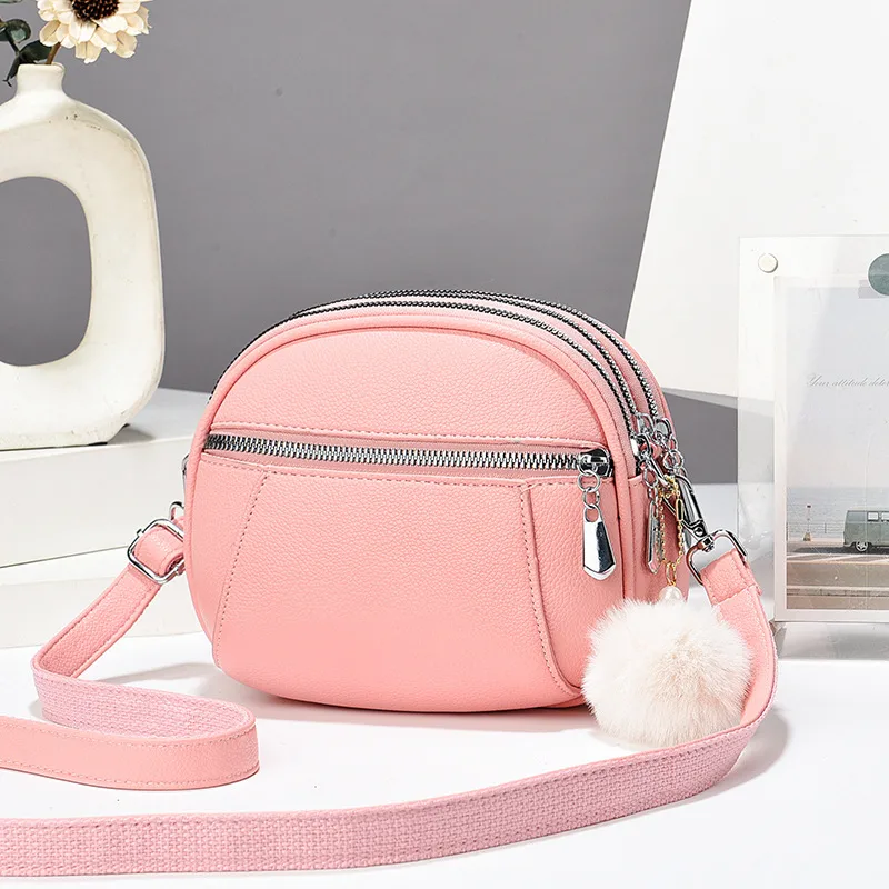 Women’s Solid Color Round Crossbody Bag In PU Leather With Fluff Ball And Single Shoulder Strap