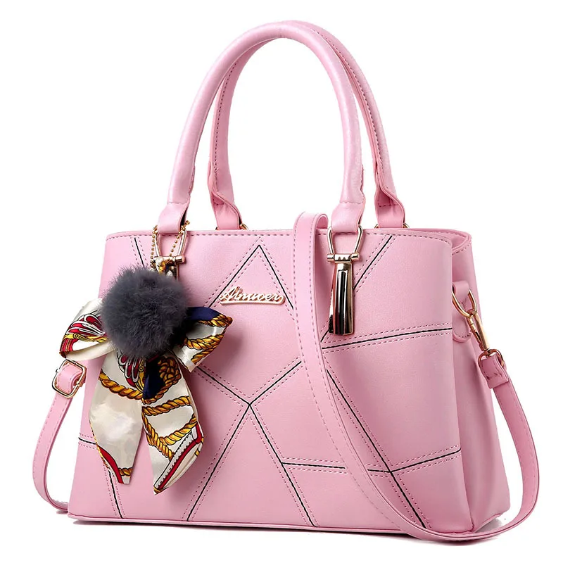 Blush handbag with angular front stitching, two short handles and a long strap