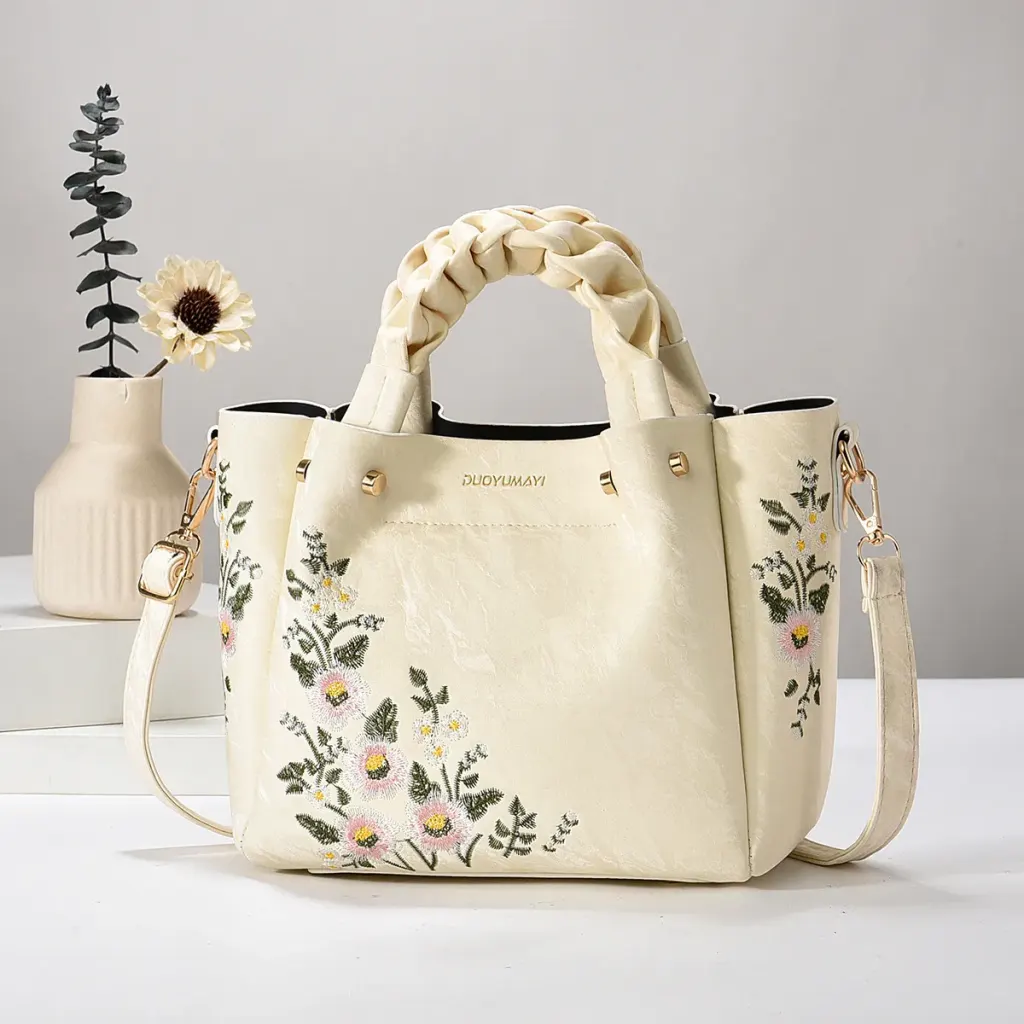 Cream Floral bag with braided handles, floral embroidery, and a long strap
