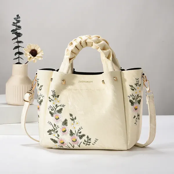 Cream Floral bag with braided handles, floral embroidery, and a long strap