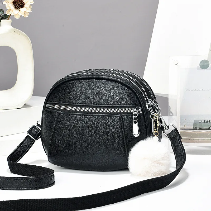 Women’s Solid Color Round Crossbody Bag In PU Leather With Fluff Ball And Single Shoulder Strap