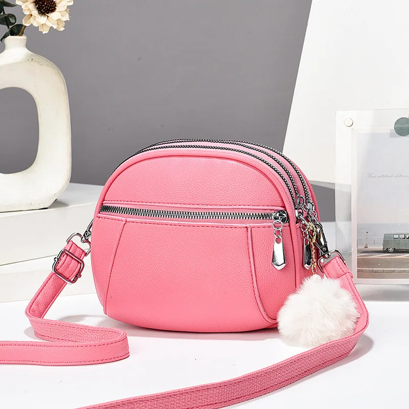 Women’s Solid Color Round Crossbody Bag In PU Leather With Fluff Ball And Single Shoulder Strap
