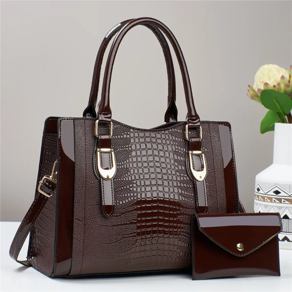 Espresso croc-embossed handbag and matching pouch against a gray backdrop