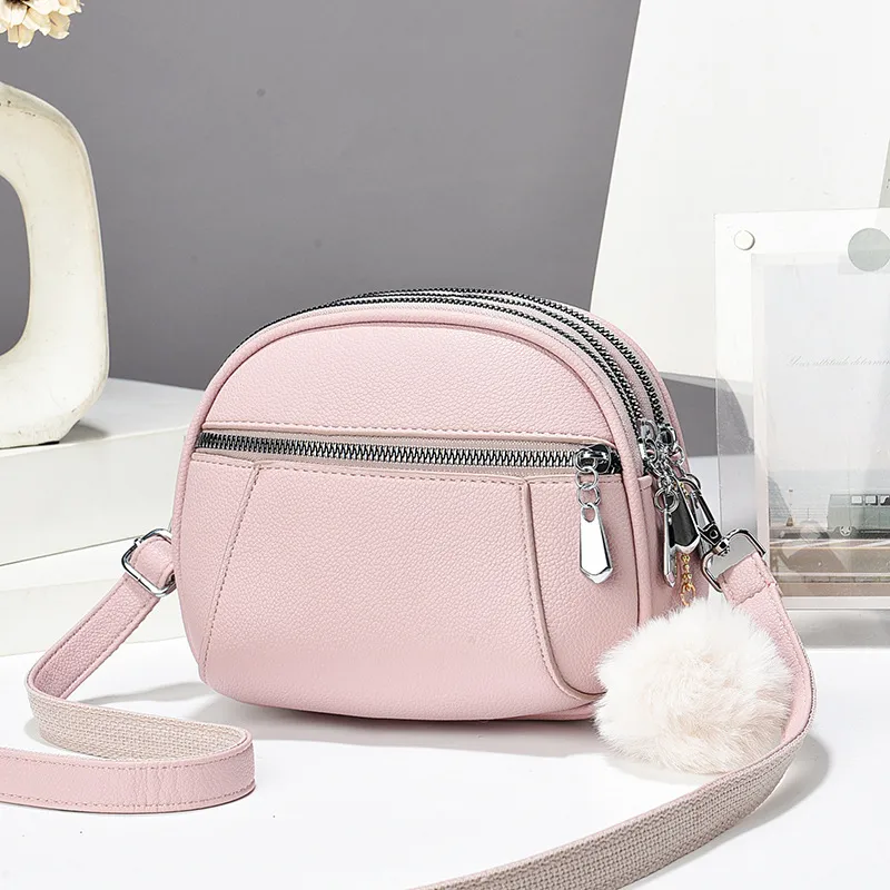 Women’s Solid Color Round Crossbody Bag In PU Leather With Fluff Ball And Single Shoulder Strap