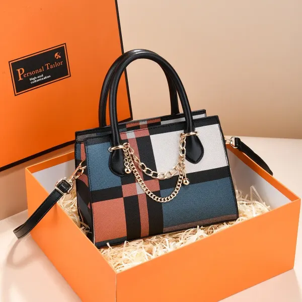 Plaid canvas tote bag displayed in a box with its shoulder strap attached.
