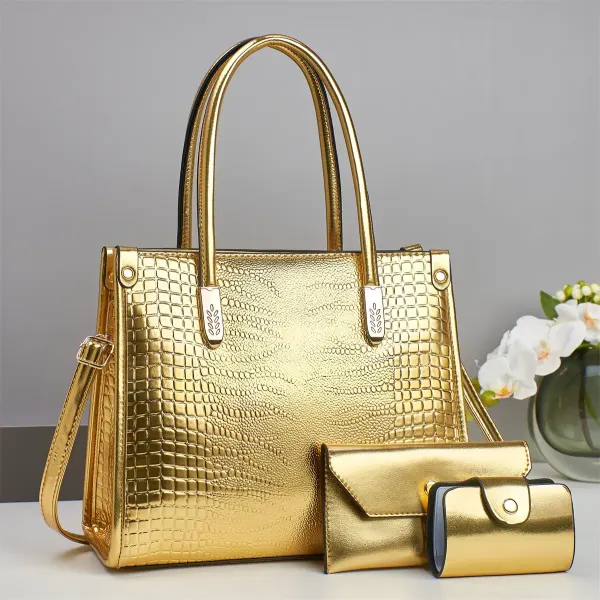Gold croc-embossed tote with two handles, a long strap and two matching accessories