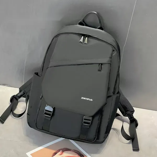 Greyish green backpack, front view, showing the rounded top, front flap, and buckle straps