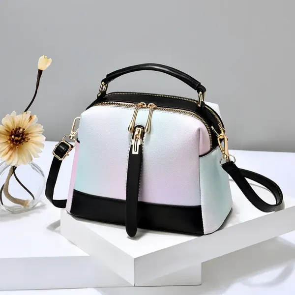 Pastel gradient handbag with black trim, a top handle, and a long strap