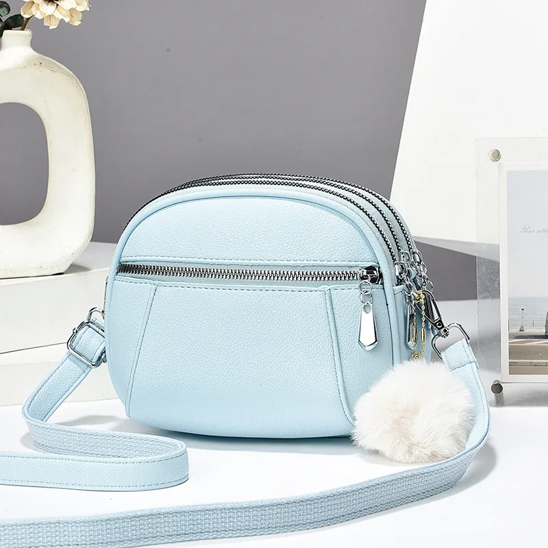 Women’s Solid Color Round Crossbody Bag In PU Leather With Fluff Ball And Single Shoulder Strap