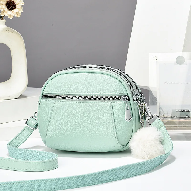 Women’s Solid Color Round Crossbody Bag In PU Leather With Fluff Ball And Single Shoulder Strap
