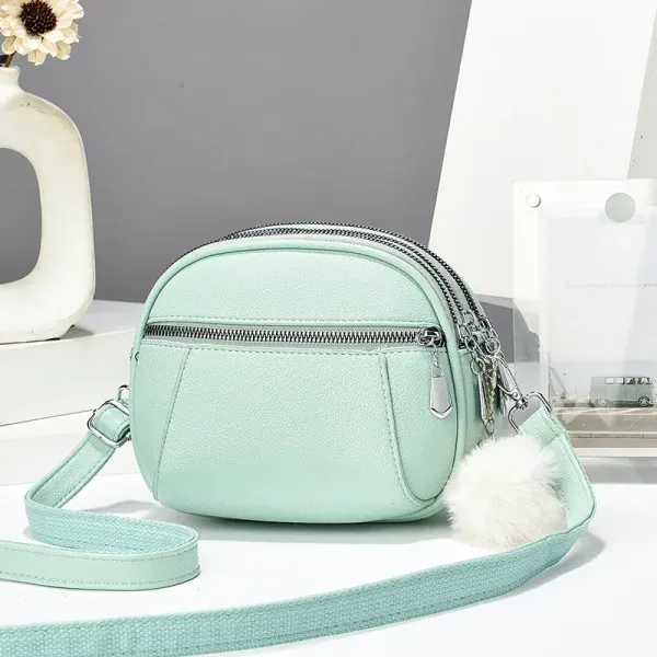 Women’s Solid Color Round Crossbody Bag In PU Leather With Fluff Ball And Single Shoulder Strap