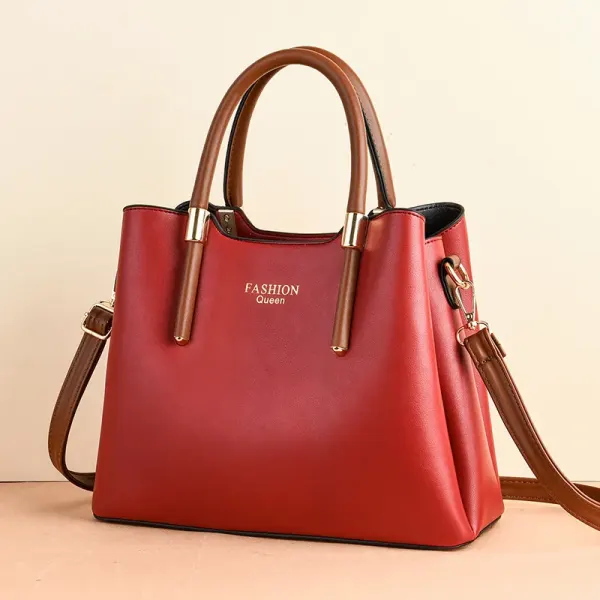 Tapered handbag with brown top handles, a long brown strap, and gold-tone collars